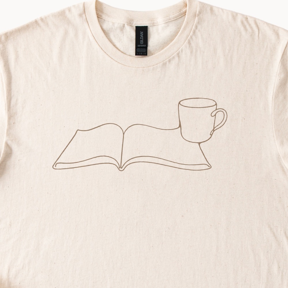 Mug Resting in an Open Book Cozy Tee
